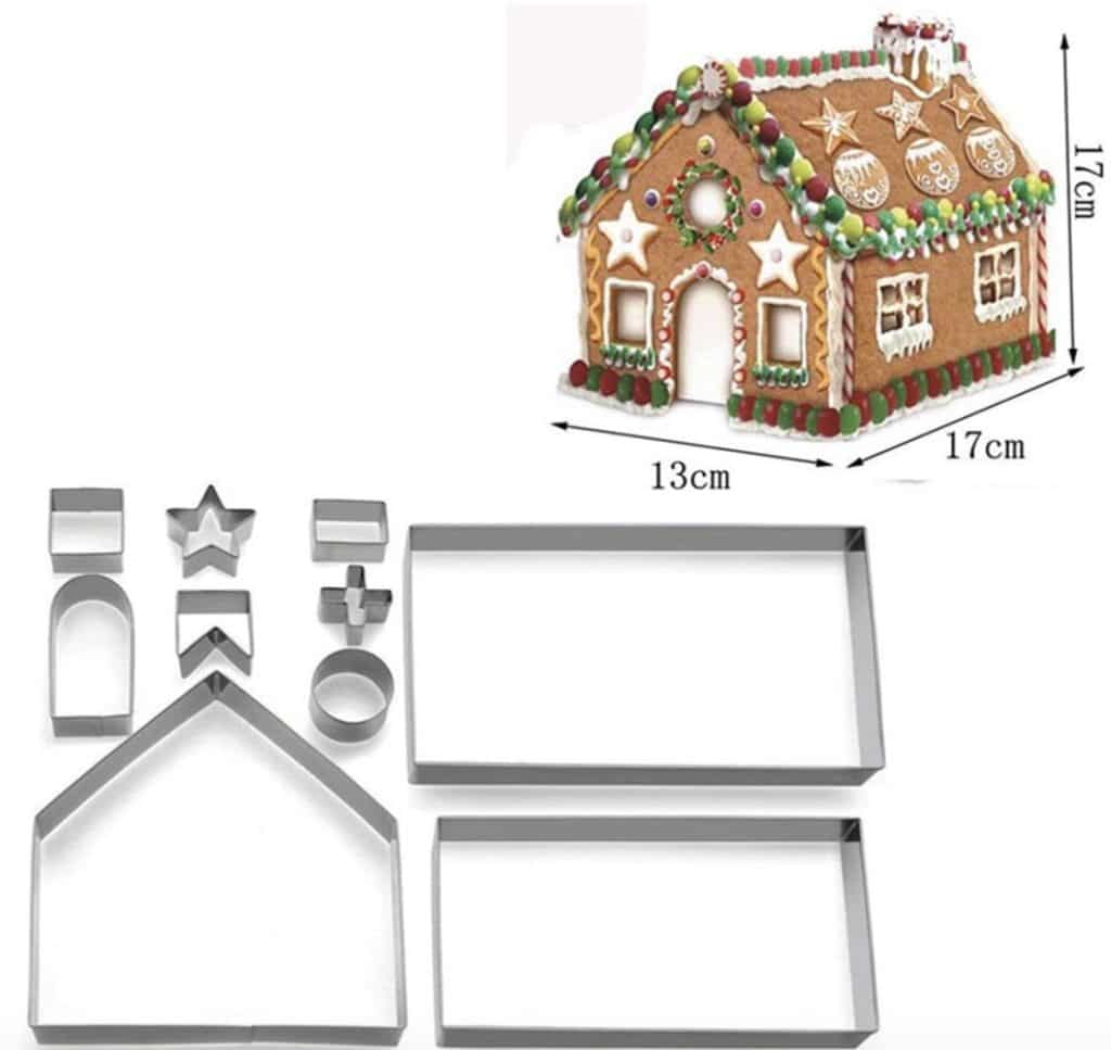 A set of metal cookie cutters in shapes like rectangles, stars, and circles is displayed alongside an air dry clay house adorned with icing and candy decorations. The charming house stands at 17cm tall, 13cm wide, and 17cm long.